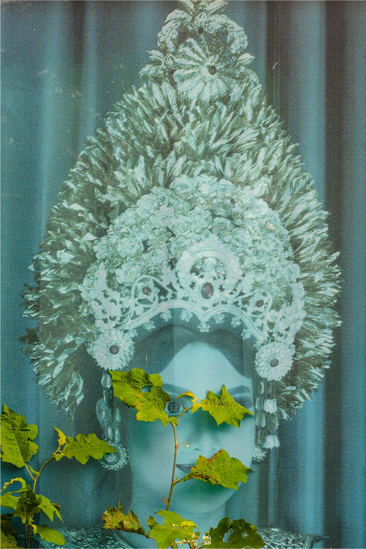 Portrait of a Balinese girl in traditional attire, hidden behind a vine, one of her eyes peeking through the leaves.